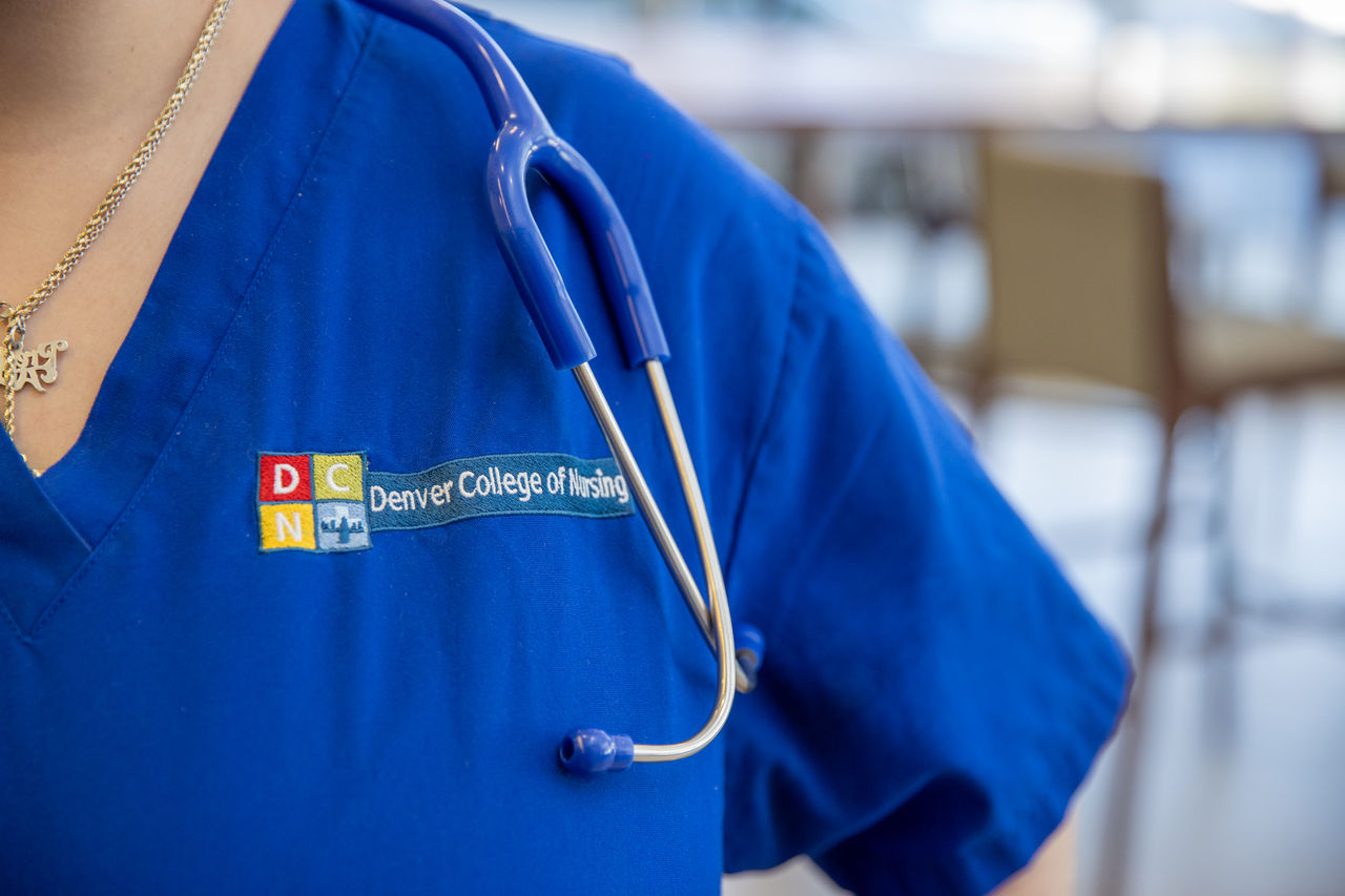 close up of scrubs with DCN logo and stethoscope